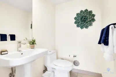 a white bathroom with a toilet and a sink at Very Chic - Bay View & Balcony - Amazing Pools- Gym in Hollywood