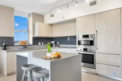 a kitchen with a counter with a plate of fruit on it at Very Chic - Bay View & Balcony - Amazing Pools- Gym in Hollywood