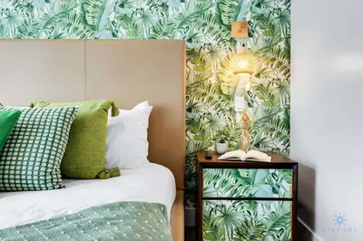 a bedroom with a bed with a green leafy wallpaper at Modern Luxury Retreat: Rooftop Pool Ocean Views in Hollywood