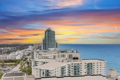 a view of a city with a building and the ocean at Oceanfront Elegance - Sunset Views, Pet-Friendly in Hollywood