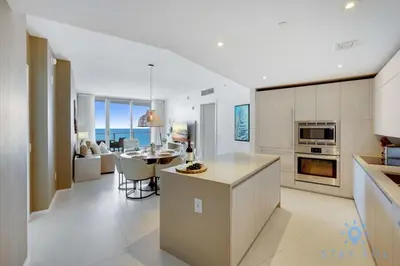 a kitchen and living room with a table and a dining room at Oceanfront Elegance - Sunset Views, Pet-Friendly in Hollywood