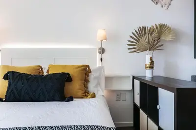a bedroom with a bed with yellow and black pillows at FREE Dinner at Crazy About You Restaurant in Miami