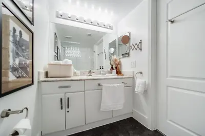 a white bathroom with a sink and a mirror at FREE Dinner at Crazy About You Restaurant in Miami