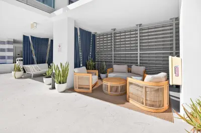 a patio with a couch and chairs and plants at MonteCarlo Miami Beach in Miami Beach