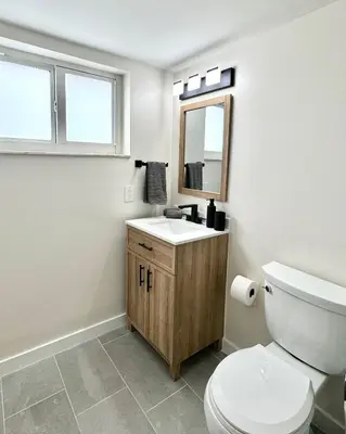 a bathroom with a toilet and a sink and a mirror at Modern / Central / Free Pkg in Miami Beach