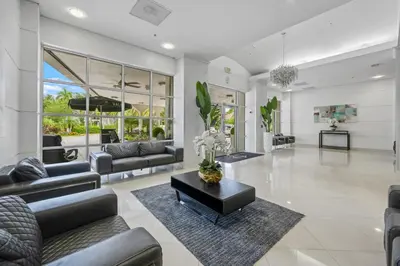 a living room with couches and a table at Spacious apartment in Ocean Reserv of 2br - 2bth great price in Sunny Isles Beach