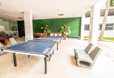 a room with a ping pong table and chairs at Spacious apartment in Ocean Reserv of 2br - 2bth great price in Sunny Isles Beach