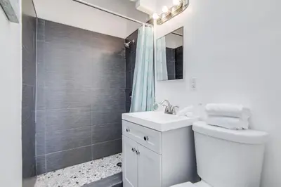 a bathroom with a toilet and a sink and a shower at Charming Large Studio Near Ocean Dr - South Beach in Miami Beach