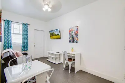 a living room with a white table and chairs at Cozy South Beach 1BR Apt Near Beach & Ocean Drive in Miami Beach