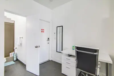 a white bathroom with a sink and a mirror at Chic Large Studio Apt Near Ocean Drive South Beach in Miami Beach