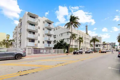 a street with cars parked in front of a building at 2B/2B, Free Parking, South Beach, 1 Block 2 Beach in Miami Beach