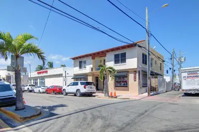 a street corner with cars parked on a street at South Beach 2BR with Private Balcony, Walk to Beach in Miami Beach