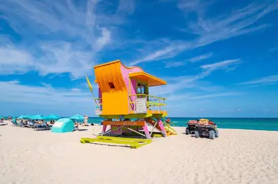 a lifeguard tower on the beach with people on the beach at 2 B/R- Heart of South Beach, Near Ocean Dr & Beach in Miami Beach