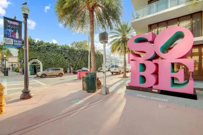 a large pink sign on the side of a street at Fun & Value Ocean Dr, South Beach, Steps to Beach in Miami Beach