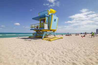 a lifeguard tower on a beach with a crowd of people at Balcony Chic Apt, w/2 Queenbeds, on Ocean Dr Beach in Miami Beach