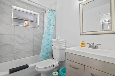 a bathroom with a toilet and a sink and a mirror at Balcony Beach View w/2 Queen beds, Ocean Dr Beach in Miami Beach