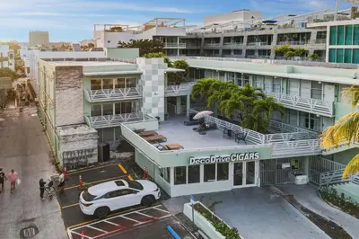 a white car parked in a parking lot in front of a building at Balcony Beach View w/2 Queen beds, Ocean Dr Beach in Miami Beach