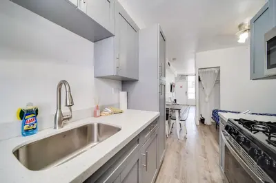 a kitchen with a sink and a stove at Ocean Drive Comfy apt, w/2 Queen Beds by the Beach in Miami Beach