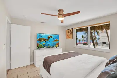 a bedroom with a bed and a ceiling fan at Beach Condo 2BR & Efficiency Combo on Hollywood Beach in Hollywood