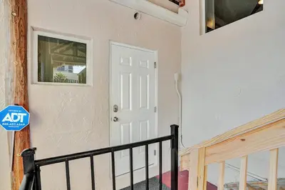 a white door in a room with a staircase at Beach Condo 2BR & Efficiency Combo on Hollywood Beach in Hollywood