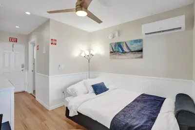 a bedroom with a bed and a ceiling fan at Beach Condo 2BR & Efficiency Combo on Hollywood Beach in Hollywood