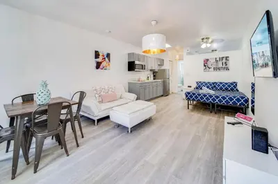 a living room and dining room with a table and a couch at Beachy 1 b/r, w/2 Queen Beds, On Ocean Drive Beach in Miami Beach