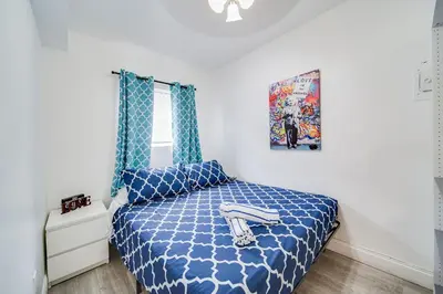 a bedroom with a bed with a blue comforter at Beachy 1 b/r, w/2 Queen Beds, On Ocean Drive Beach in Miami Beach