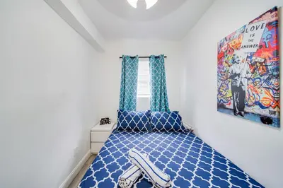 a bedroom with a blue bed with a picture on the wall at Beachfront 1 bedroom with 2 Queen Beds on Ocean Drive in Miami Beach