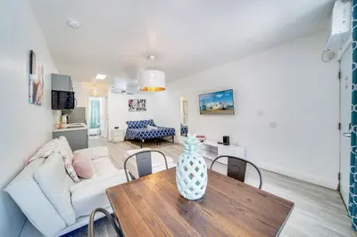 a living room with a table and a couch at Beachfront 1 bedroom with 2 Queen Beds on Ocean Drive in Miami Beach