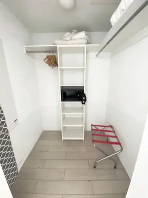 a walk in closet with a desk and a chair at 2 Full Beds, Modern Vibes, Coastal Location in Hallandale Beach