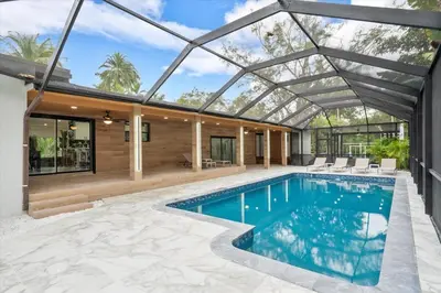a swimming pool in a house with a glass roof at VillaKOBO Heated pool Spa Golf Tennis crocodile in Miami