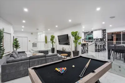 a living room with a pool table in it at VillaKOBO Heated pool Spa Golf Tennis crocodile in Miami