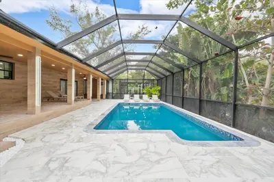 an indoor pool in a house with a glass ceiling at VillaKOBO Heated pool Spa Golf Tennis crocodile in Miami