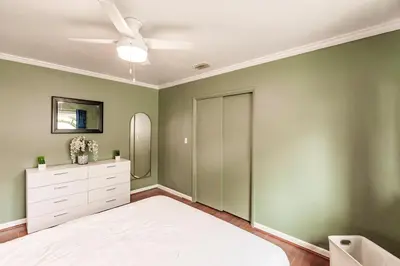 a bedroom with green walls and a white dresser at Uhost AI - Updated 1B1B Hideaway - Sleeps 3 in Hollywood