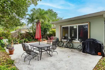 a patio with a table and chairs and an umbrella at Uhost AI - Updated 1B1B Hideaway - Sleeps 3 in Hollywood