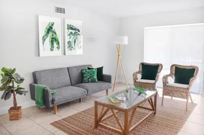 a living room with a couch and two chairs at Suites at Coral Resorts in Miami