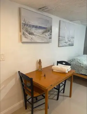 a dining room table with two chairs and a bed at CHEERFUL PRIVATE ROOM 2 MILES AWAY FROM SUNNY ISLES BEACH in North Miami Beach