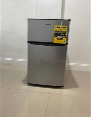 a refrigerator with a sign on it sitting on a floor at CHEERFUL PRIVATE ROOM 2 MILES AWAY FROM SUNNY ISLES BEACH in North Miami Beach