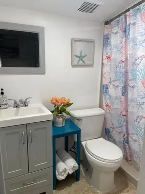 a bathroom with a white toilet and a sink at CHEERFUL PRIVATE ROOM 2 MILES AWAY FROM SUNNY ISLES BEACH in North Miami Beach