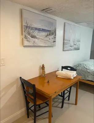a dining room table with two chairs and a bed at CHEERFUL PRIVATE ROOM 2 MILES AWAY FROM SUNNY ISLES BEACH in North Miami Beach