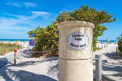 a pole with a sign on it on the beach at Deco Apt w/2 Queen Beds on Ocean Dr, South Beach in Miami Beach