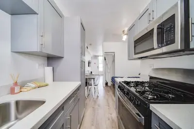 a kitchen with a sink and a stove top oven at Deco Ocean Dr Deal, w/2 Queen Beds, South Beach in Miami Beach