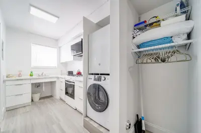 a white laundry room with a washer and dryer at Deco Beachside Apt, w/2 Queen Beds, Washer/Dryer in Miami Beach