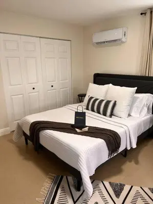 a bedroom with a large bed with white blankets and pillows at Casita Cafe in Miami