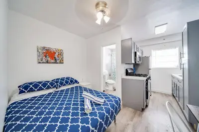 a bedroom with a blue bed and a bathroom at Fresh Ocean Dr, Apt w/2 Queen Beds-Steps 2 Beach in Miami Beach