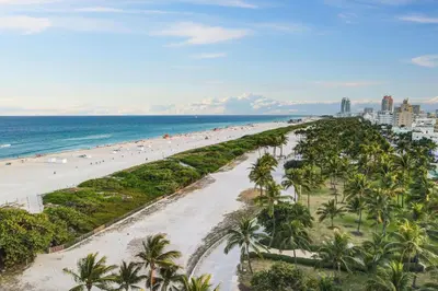 an aerial view of a beach with palm trees and the ocean at Fresh Ocean Dr, Apt w/2 Queen Beds-Steps 2 Beach in Miami Beach