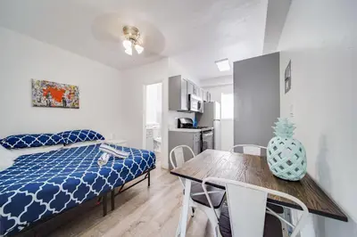 a bedroom with a bed and a table and chairs at Fresh Ocean Dr, Apt w/2 Queen Beds-Steps 2 Beach in Miami Beach