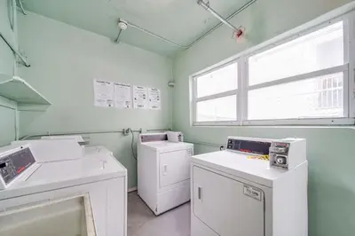 a laundry room with white appliances and a window at Ocean Drive Beach Fun, w/2 Queen Beds South Beach in Miami Beach