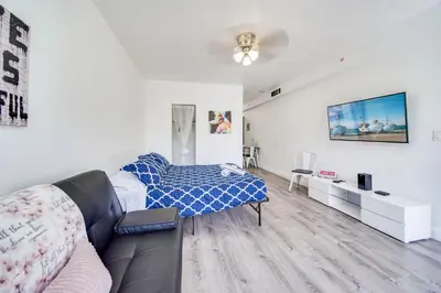a living room with a bed and a couch at Ocean Drive Beach Fun, w/2 Queen Beds South Beach in Miami Beach