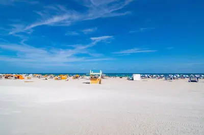 a beach with a bunch of chairs and people on it at Ocean Drive Best Deal, w/2 Queen Beds, Near Beach in Miami Beach